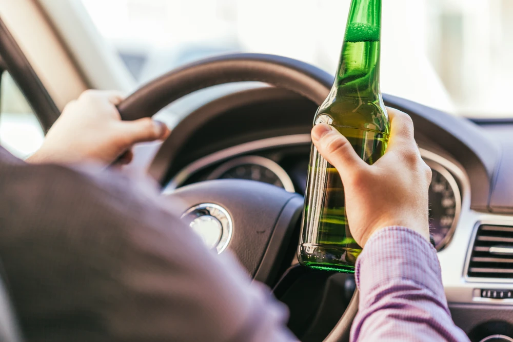 man-drinking-alcohol-while-driving-the-car-2025-02-24-21-15-56-utc